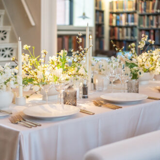 Plan the perfect winter-themed holiday party with beautiful white decor and twinkling lights with The Catered Affair.